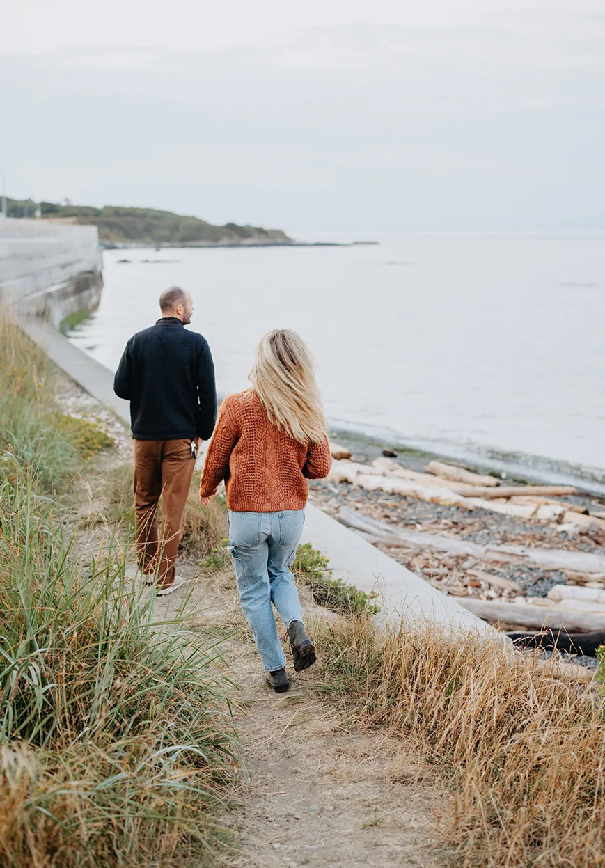 Couple walking on beach at sunset